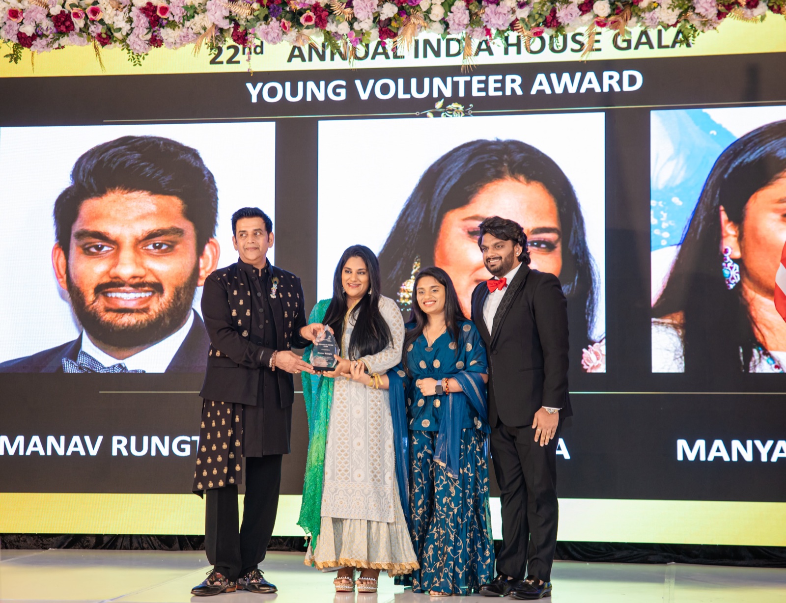 Manasi receiving her award alongside Manya and Manav