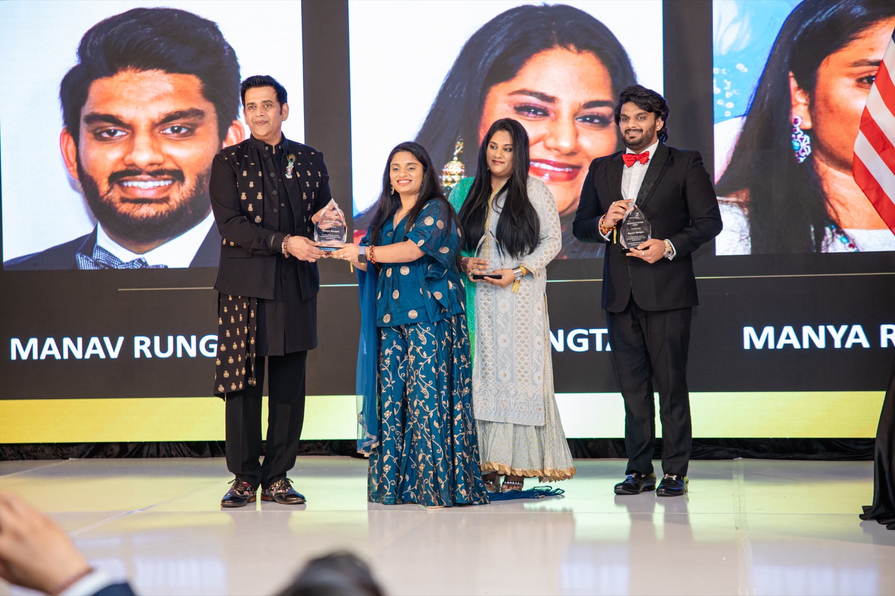 Manav, Manasi, and Manya Rungta receiving their Young Volunteer Awards at the India House Gala